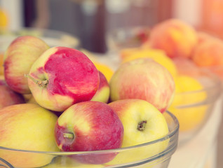 Fresh apple, lemons and peach in the background. Fruit for making fresh juice.