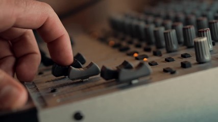 Sound Engineer Moving Sliders In Radio Station.Soundboard Pads On TV Station.Engineer Press Key Buttons On Control Desk Recording Studio.Sound Designer Used Digital Audio Mixer In Production Studio