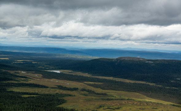 panoramic overview over a valley with forest and lakes in sweden on a cloudy day © stalmphotos