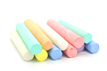 Multi-colored crayons on a white background. Colored chalk. Wallpaper. Art supplies. Children's stationery. The tool of the artist. Materials for creativity. Hobby goods.