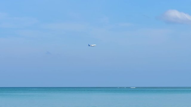 Airplane approaching over ocean