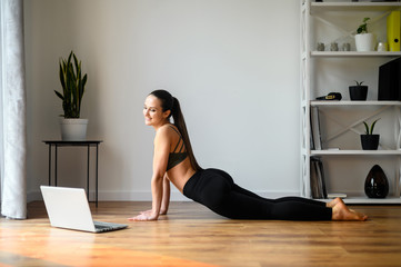 Fototapeta premium Female yoga coach records video tutorial