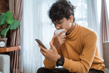 sick man coughing while sitting on a couch