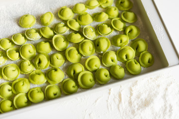 The process of sculpting dumplings. Green dumplings with cheese. Russian dumplings