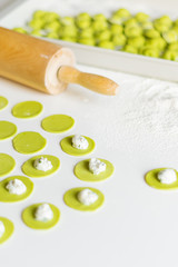 The process of sculpting dumplings. Green dumplings with cheese. Russian dumplings