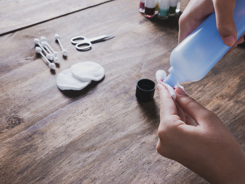 girl's hands removing her nail varnish, beauty treatment concept