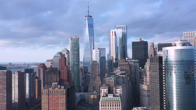 Dolly in aerial of freedom tower; cloudscape; slow and smooth