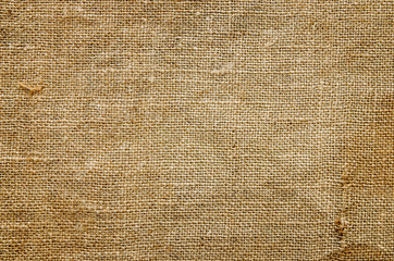 A fragment of an old burlap. Textural background.