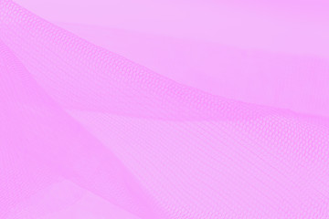 Light small mesh fabric on pink background. Shades of pink