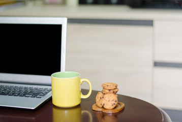 Chocolate butter cookies with coffee cups and laptops On the desk at home