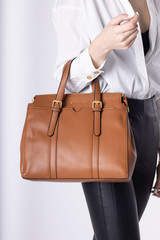  Model girl with leather elegant women bag. Fashionable female handbag, isolated