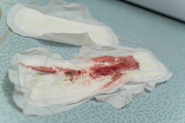 Fototapeta na wymiar Dirty used gasket in menstruation blood
