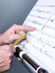 masculine hands working on a score, musical composition concept