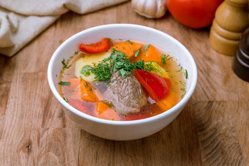 shurpa asian soup with meat and vegetables on wooden table