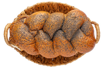 Fresh loaf in a wicker basket isolated on white background. Bread viewed from above
