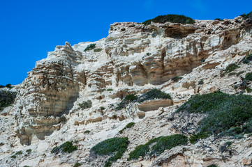 A fresh spring wind drives the waves to the coast of Cyprus. The Mediterranean Sea is painted with dark ultramarine and a luminous azure from the inside.     