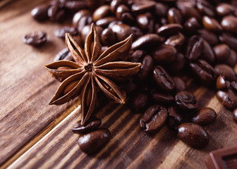 Closeup of Coffee beans, anis on the wood brown table. Flat Lay with no people