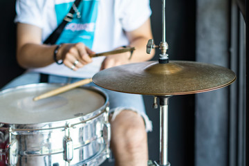 A man drummer playing musical on drums.