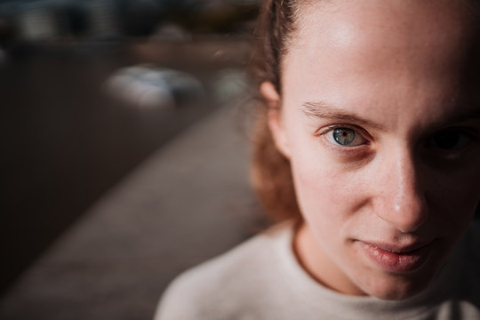 Natural young girl with blue eyes and blonde hair. Half face portrait.