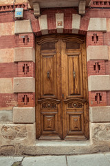 Fototapeta premium Old wooden door, brick facade