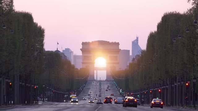 View of Champs-elysees avenue and Arc de Triomphe at sunset, Paris, France.