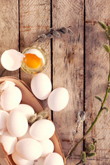 Spring still life with white chicken eggs and willow branches.