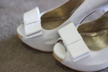 Wedding concept. Bride's white shoe.