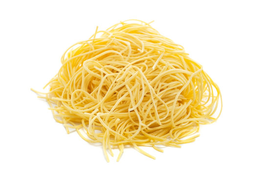 Fresh uncooked capellini pasta isolated on a white background