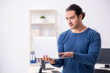 Young male it specialist working in the office