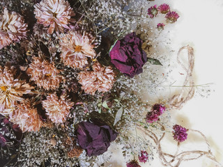 Dry flowers on light fur as background decor