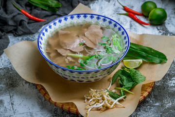 Soup Pho Bo with beef on grey table. Vietnamese cuisine.