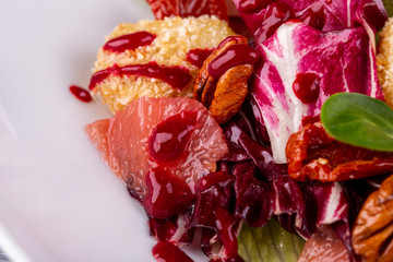 Salad with chicken fillet in bread crumbs, served with pecan nuts and fresh salad