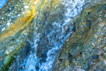 The flow of the river along the stones