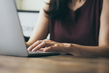 Naklejka premium work from home.using computer.hand typing keyboard laptop online chatting search form internet while working sitting on sofa.concept for technology device contact communication business people