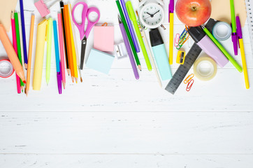 Children's accessories for study, creativity and office supplies on a white wooden background. Back to school concept. Copy space