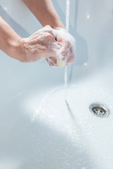 Fototapeta premium Coronavirus pandemic prevention wash hands with soap warm water