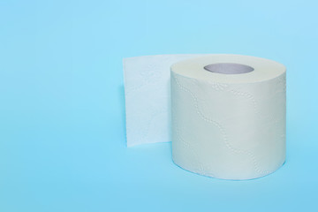Roll of toilet paper on a blue background. Toilet paper purchase due to kronavirus concept. Cleanliness, Hygiene, Sterility, stop the spread of the virus