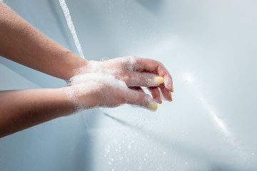 Fototapeta premium Coronavirus pandemic prevention wash hands with soap warm water