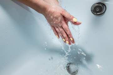 Coronavirus pandemic prevention wash hands with soap warm water