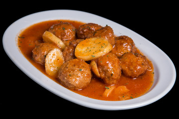 Cutlets with potato in tomato sauce