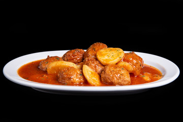 Cutlets with potato in tomato sauce