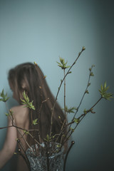 young woman holding a tree