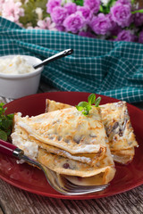 Crepes with ricotta cheese and blackcurrant jam.