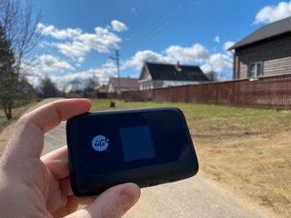 mobile wifi router in hand in the village