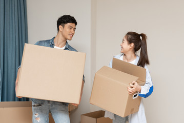 A young asian couple is moving to a new home