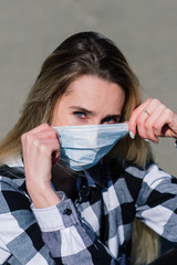 Portrait of a teenage in a medical mask with logboard during the quarantine period