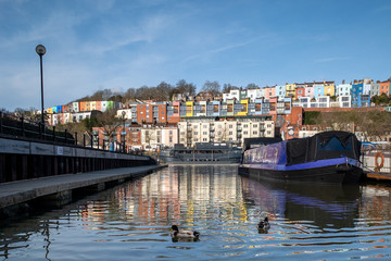 A view across Bristol harbour towards colourful houses in Hotwells and Cliftonwood. 