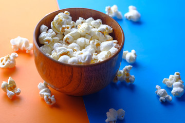 high angle view of popcorn in a bowl on color background 