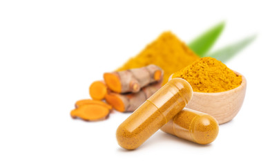  dry Turmeric powder in capsule  isolated on white background.