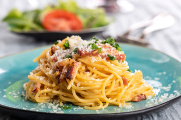 spaghetti carbonara on a blue plate - 338100089